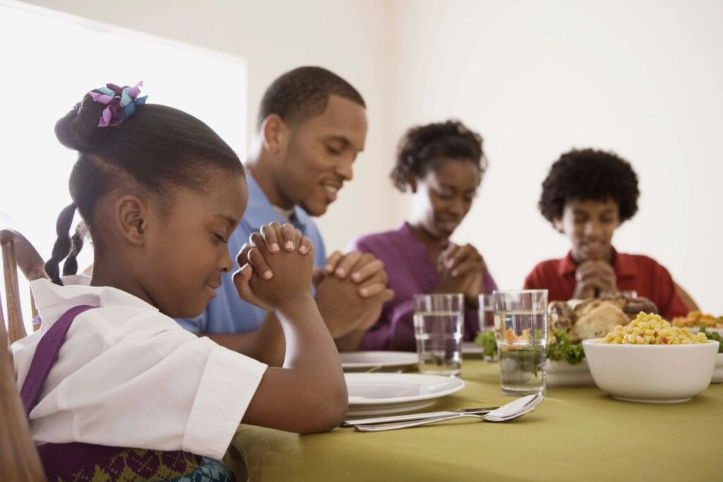 a family praying at a table